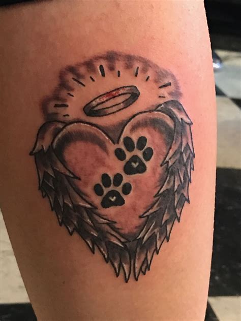 paw print tattoo|paw print with halo tattoo.